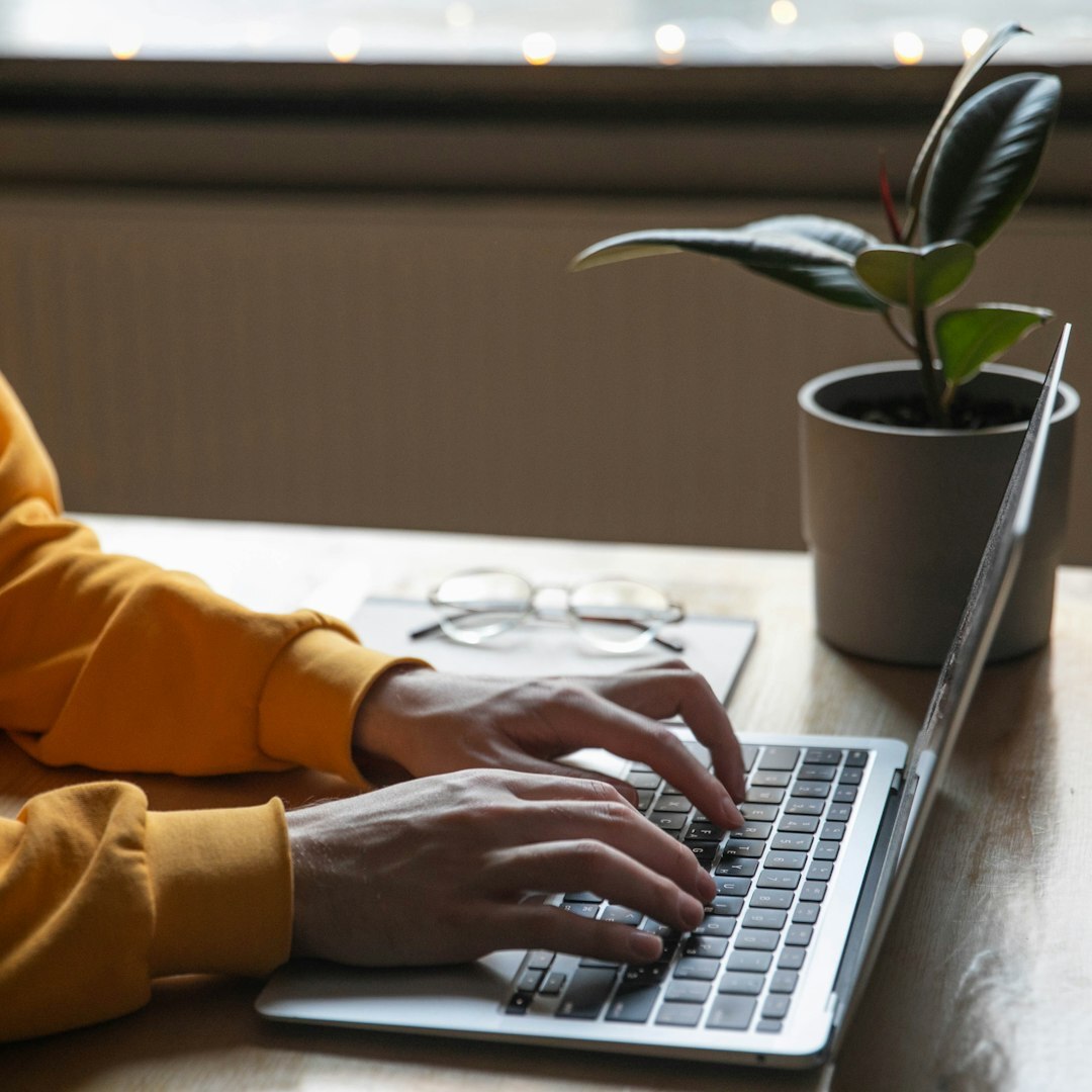 writer typing on laptop
